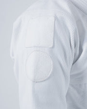 Kingz Born to Rule Women's Jiu Jitsu Gi White - Close-Up Detail View Shoulder Reinforced Stitching Square and Circle Patches Textured Fabric Durable Construction BJJ Gi Training [color:White]