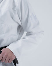 Kingz Born to Rule Women's Jiu Jitsu Gi - White - Close-Up Detail View White Crown Badge Textured Fabric Black Belt BJJ Gi Training Apparel [color:White]