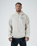 Tan BJJ Champion hoodie front view on adult male model showing blue Champion Mentality chest script