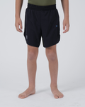 Kingz Trooper Youth Shorts Black Olive - Full Body Front View Teen Boy Athlete Solid Black Blue KINGZ Badge Right Thigh Flag Badge Left Leg Inner Compression Shorts Visible Competition Cut Kids Grappling Shorts No-Gi BJJ