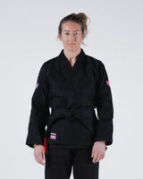 Kingz Empowered Women's Jiu Jitsu Gi - Black - Front View Female Athlete Black Gi Pink Accents Kingz Logo Left Waist Pink Crown Badge Sleeves Durable Weave Women's BJJ Gi Training [color:Black]