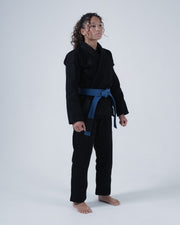 Kingz Born to Rule Women's Jiu Jitsu Gi - Black - Full Body Front View Female Athlete Solid Black Gi Blue Belt Minimalist Design Patch Details Durable Fabric BJJ Training Gi [color:Black]