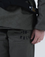 Kingz Born to Rule Women's Jiu Jitsu Gi Military Green - Close-Up Detail View Black Embroidered Text "TO RULE" Diamond Weave Pattern Black Belt Crown Badge BJJ Gi Training Apparel [color:Military Green]