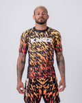 Kingz Flame Rashguard Orange Black - Full Body Front View Male Athlete Short Sleeve Flame Tiger Stripe Pattern Orange Yellow Black Ombre Sublimated KINGZ White Text Chest Matching Flame Pattern Shorts Grappling BJJ MMA No-Gi