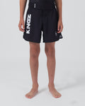 Kingz Kore V2 Youth Shorts Black - Full Body Front View Teen Boy Athlete Solid Black Bold Vertical KINGZ White Text Left Leg Circular Crown Badge Right Competition Cut Kids Grappling Shorts No-Gi BJJ Kore Collection