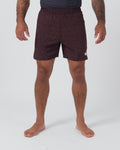 Kingz Hybrid Shorts Noise Red - Full Body Front View Male Athlete Dark Burgundy Maroon Red Noise Speckle Texture Pattern White Crown Logo Right Thigh Black Elastic Waistband Inner Compression Shorts Competition Cut Men's Grappling Shorts No-Gi BJJ