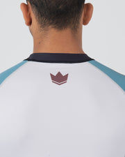 Kingz Flow Rashguard Blue/Pink - Back View Close-Up Male Athlete White Back Blue Sleeves Maroon Crown Logo Upper Back Contrast Stitching BJJ No-Gi Grappling Rash Guard [color:Blue/Pink]