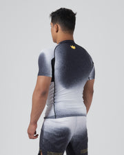 Kingz Galaxy Rash Guard Black White - Full Body Back View Male Athlete Short Sleeve Black To White Ombre Galaxy Pattern Gold Crown Logo Center Back Matching Galaxy Spats Leggings KINGZ Gold Text Bottom BJJ MMA [color:Black/Galaxy]