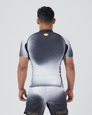 Kingz Galaxy Rash Guard Black White - Full Body Straight Back View Male Athlete Short Sleeve Black Upper Back To White Lower Ombre Galaxy Spatter Pattern Gold Crown Logo Center Back Matching Galaxy Spats Leggings KINGZ Gold Text [color:Black/Galaxy]