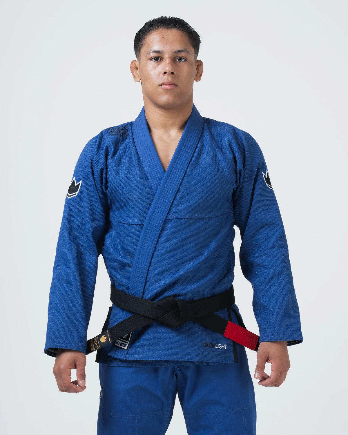 Kingz Ultralight 2.0 Jiu Jitsu Gi Blue - Front View Male Athlete Blue Gi Black Belt Crown Logo Shoulders KINGZ Patch Left Lapel Lightweight Design BJJ Gi Training [color:Blue]