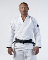 Kingz Kore V2 Jiu Jitsu Gi - White - Front View Male Athlete White Gi Black Belt Kingz Logo Left Hem Crown Badge Left Arm Traditional Cut Durable Fabric BJJ Gi Training [color:White]