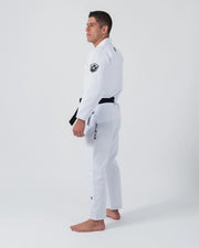 Kingz Balistico 4.0 Brazilian Jiu Jitsu Gi - White - Side View Male Athlete Black Belt Crown Badge Shoulder BALISTICO Text Pant Leg Reinforced Stitching Durable Fabric BJJ Gi Training [color:White]