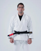 Kingz Born to Rule Jiu Jitsu Gi - White - Full Body Front View Male Athlete Embroidered Logo Chest Contrast Black Belt Red Patch Traditional Fit Durable Fabric BJJ Gi [color:White]