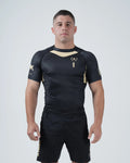 Kingz Player Special Limited Edition Rashguard Black Gold - Full Body Front View Male Athlete Short Sleeve Black Gold Chevron Motorsport Design Number 1 Crown Logo Tainan Dalpra