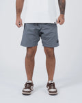 Kingz Casual Gi Shorts Grey Steel Blue-Grey - Full Body Front View Male Athlete Grey Ripstop Casual Shorts Above-Knee Cut Drawstring Waistband Black Woven Kingz Label Right Thigh White T-Shirt Brown Nike Dunk Sneakers Men's BJJ Lifestyle