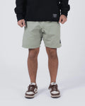 Kingz Casual Gi Shorts Sage Stone Green - Full Body Front View Male Athlete Sage Stone Green Ripstop Casual Shorts Above-Knee Cut Elastic Leg Hem Drawstring Waistband Black Woven Kingz Label Right Thigh Black Hoodie Brown Nike Dunk Sneakers Men's BJJ Lifestyle