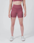 Kingz Kore Women's Training Shorts Red Dusty Rose - Full Body Front View Female Athlete Dusty Rose Mauve Biker Style Short Cut High-Waist Wide Waistband KINGZ White Text Right Thigh Matching Mauve Sports Bra White Sneakers Women's Training Shorts No-Gi BJJ Kore Collection