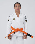 Kingz Comp V6 Youth BJJ Gi White - Upper Body Front View Teen Athlete Orange Belt HEAVY LIES THE CROWN Patch Crown Logo 450gsm