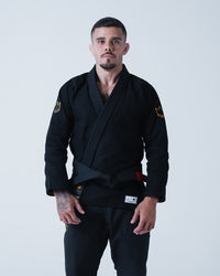 Kingz Legends Never Die Respect Gi - Black - Full Body Front View Male Athlete Black Gi Gold Crown Shoulder Embroidery Kingz Patch Lower Lapel Durable Fabric BJJ Gi Training Grappling [color:Black]