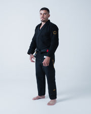 Kingz Legends Never Die Respect Gi - Black - Full Body Front View Male Athlete Black Gi Yellow Crown Badge Sleeve Red Tab Waist Bold KINGZ Text Leg BJJ Gi Training [color:Black]