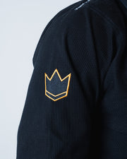 Kingz Legends Never Die Respect Gi Black - Close-Up Detail View Black Fabric Orange Crown Badge Embroidered Logo Textured Material Shoulder Area BJJ Gi [color:Black]