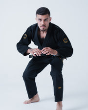 Kingz Legends Never Die Respect Gi - Black - Full Body Front View Male Athlete Black Gi Gold Crown Shoulder Patches Embroidered Logos Durable Fabric BJJ Training Gi [color:Black]