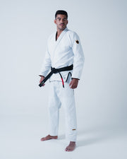 Kingz Legends Never Die Respect Gi - White - Full Body Front View Male Athlete White Gi Black Belt Crown Badge Sleeve KINGZ Logo Pant Leg Traditional Fit BJJ Gi Training [color:White]