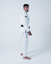 Kingz Legends Never Die Respect Gi - White - Side View Male Athlete White Gi Black Belt Crown Badge Shoulder and Thigh Durable Fabric Classic Fit BJJ Gi Training Martial Arts [color:White]