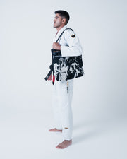 Kingz Legends Never Die Respect Gi - White - Side View Male Athlete Black Crown Badge Sleeve Bold ULTRALIGHT Text Pants KINGZ Logo Ankle Black Belt Contrast BJJ Gi Training [color:White]