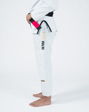 Kingz Legends Never Die Respect Women's Gi White - Side View Female Athlete Black Belt Pink Sleeve Trim Black Waistband ULTRALIGHT Vertical Text Yellow KINGZ Logo Ankle BJJ Gi Training [color:White]