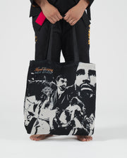 Kingz Legends Never Die Respect Women's Gi - Black - Close-Up Front View Black Gi Pants Gold Crown Badge Right Thigh Pink Belt Accent Barefoot Athlete BJJ Training [color:Black]